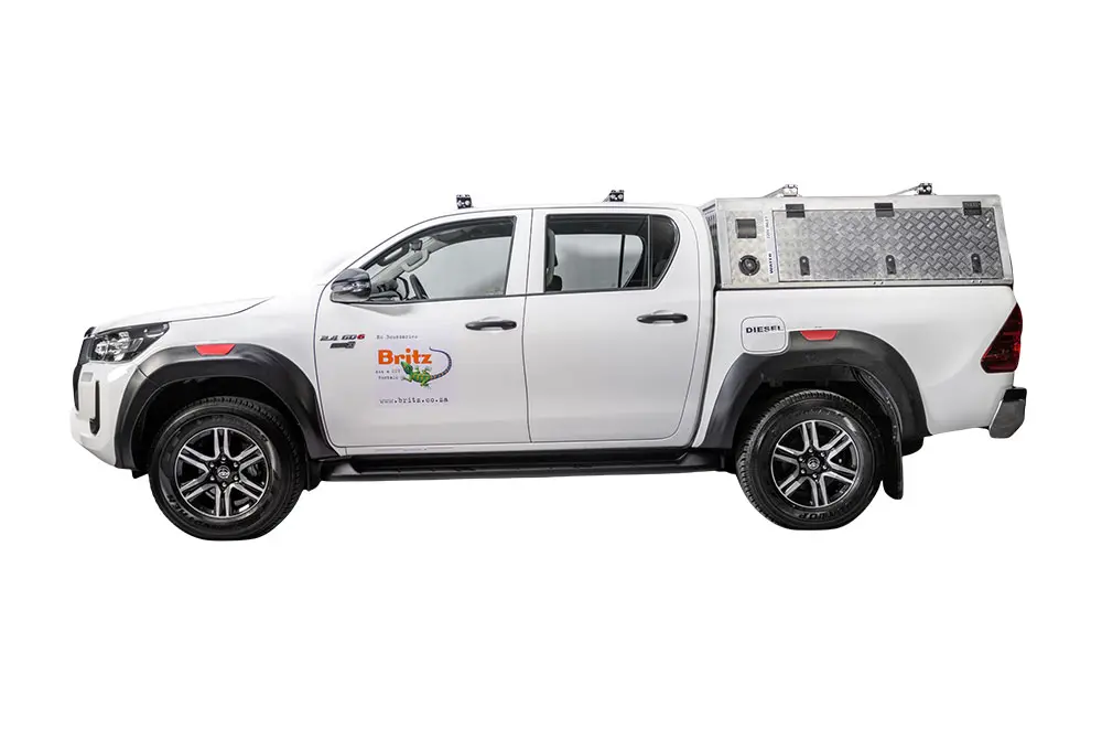 White Britz Toyota Hilux double cab 4x4, a reliable unequipped vehicle for exploring diverse terrains in South Africa.
